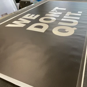 white letters that say we don't quit on black background