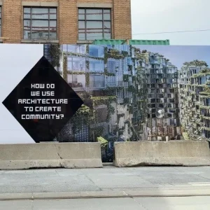 hoarding signage for a new condo development on the side of the road