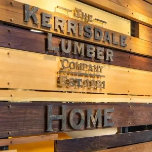 Metal 3d letter signage installed on wood wall