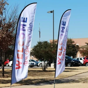 two feather flag banners that say welcome