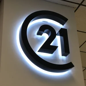 black channel letter logo sign with white led halo lighting