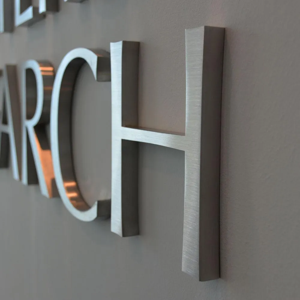 silver cut metal letters on wall