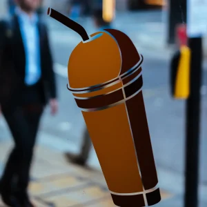 cut vinyl decal of a brown beverage cup on window