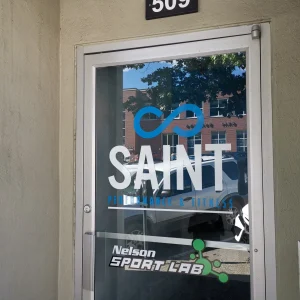 blue and white sign of a fitness facility on glass door