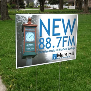 a custom printed lawn sign advertising a radio station