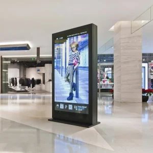 A sign structure that has a vertical monitor in a mall.