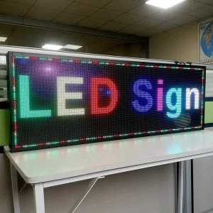 A electronic sign board on a table that shows "LED Sign"