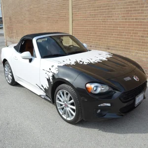 A convertible car with partial wrap.