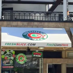 awning sign of a pizza shop on a white awning