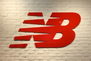 dimensional-letter-sign-10-1.5-L Red large New Balance logo installed on white brick wall in store