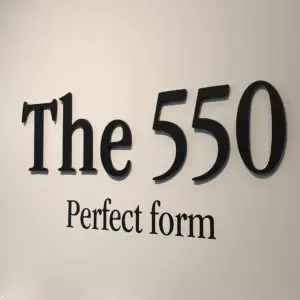 Black 3D letters that say The 555 installed on a white wall