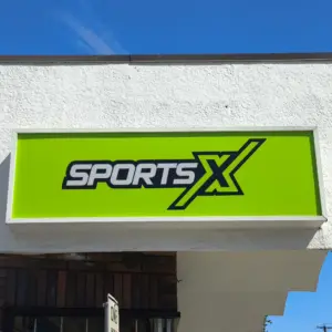 Light box sign with logo of company on a green background