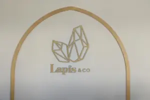lobby-sign-7-1.5-L Gold 3d letter and logo for a spa installed in the lobby of business