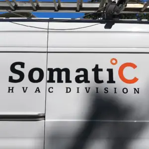 Cut vinyl lettering of company logo and words HVAC division on the side of a white van