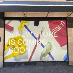 Temporary wall hoarding graphics that says new store is coming