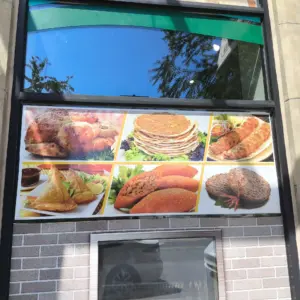 window graphics displaying various foods of a middle eastern grocery store